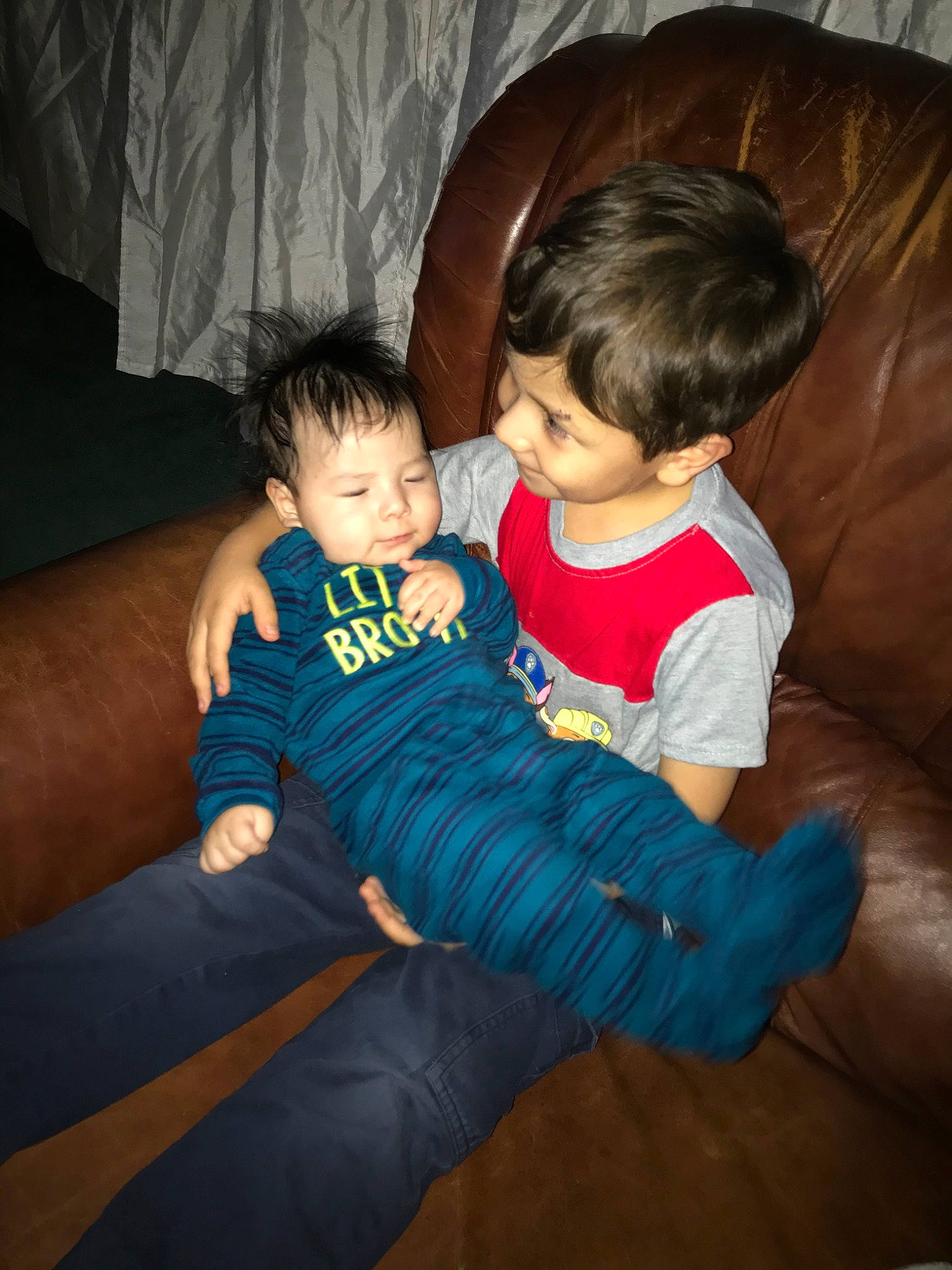 Justin Jr is registered to the contest to win money with this photo: arm, baby, cheek, child, eye, family, fun, interaction, iris, lap, leg, people, person, play, sibling, sitting, skin, smile, toddler