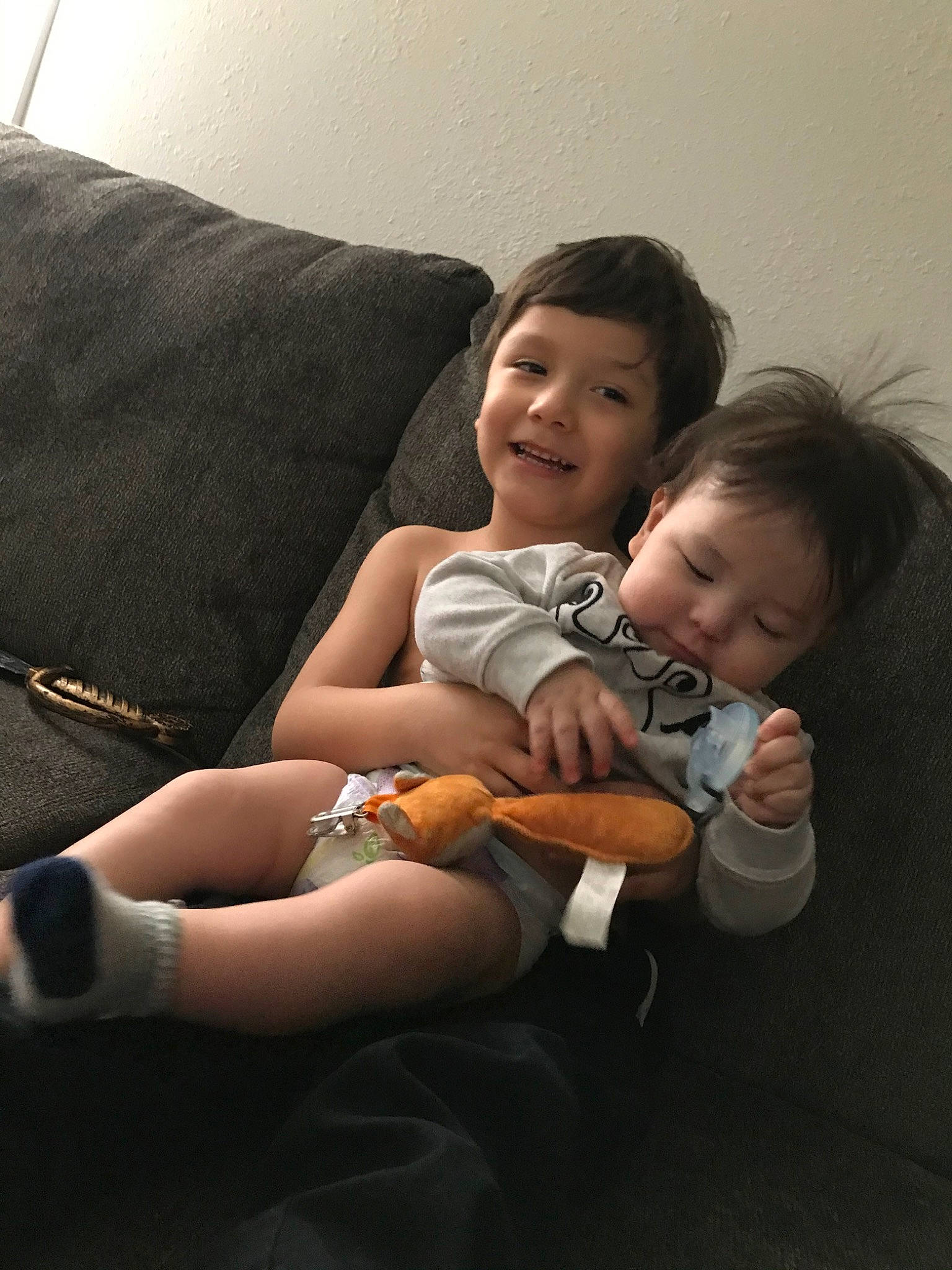 James is registered to the contest to win money with this photo: arm, baby, cheek, child, comfort, daughter, electronic_device, fun, happy, joint, joy, leg, nose, people, person, sibling, sitting, skin, smile, snapshot