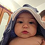Ronald joined the competition — help win amazing prizes! baby, child, towel, hooded_towel, face, eyes, skin, hand, indoor, cabinet, wood, person, portrait, soft, curious, closeup, holding, baby_skin, expression, room