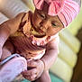 baby, infant, child, pink, headband, bow, shoe, curious, couch, soft_focus, indoors, closeup, skin, hand, footwear, sitting, cute, portrait, young, exploring