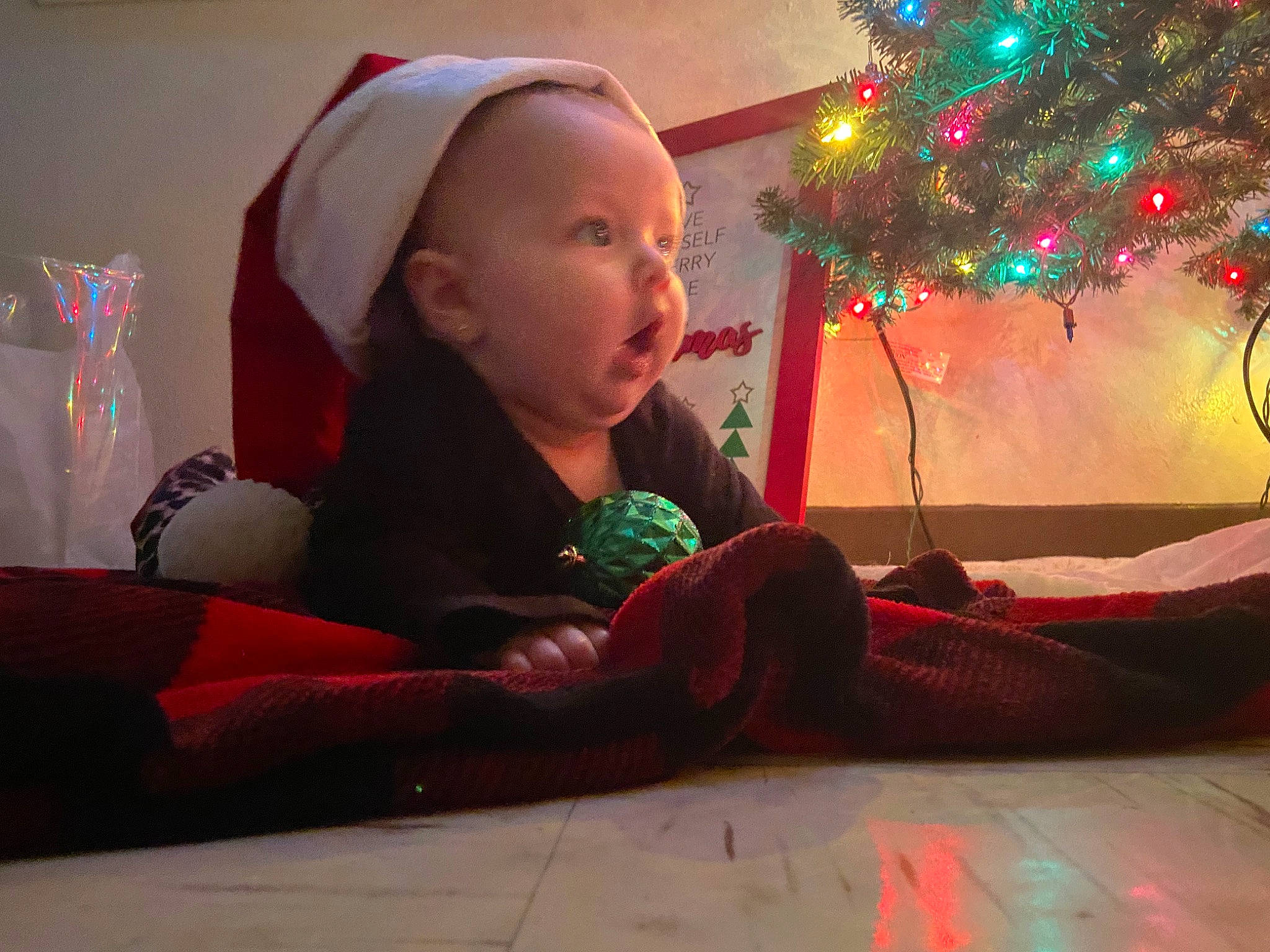 Maisie joined the competition — help win amazing prizes! baby, beauty, carmine, child, christmas, christmas_decoration, christmas_eve, christmas_ornament, christmas_tree, comfort, event, fun, happy, holiday, lap, ornament, person, room, sitting, toddler