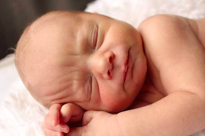 Ryker is registered to the contest to win money with this photo: arm, baby, cheek, chin, comfort, ear, eyebrow, eyelash, face, finger, gesture, head, human_body, lip, mouth, nail, neck, nose, person, skin