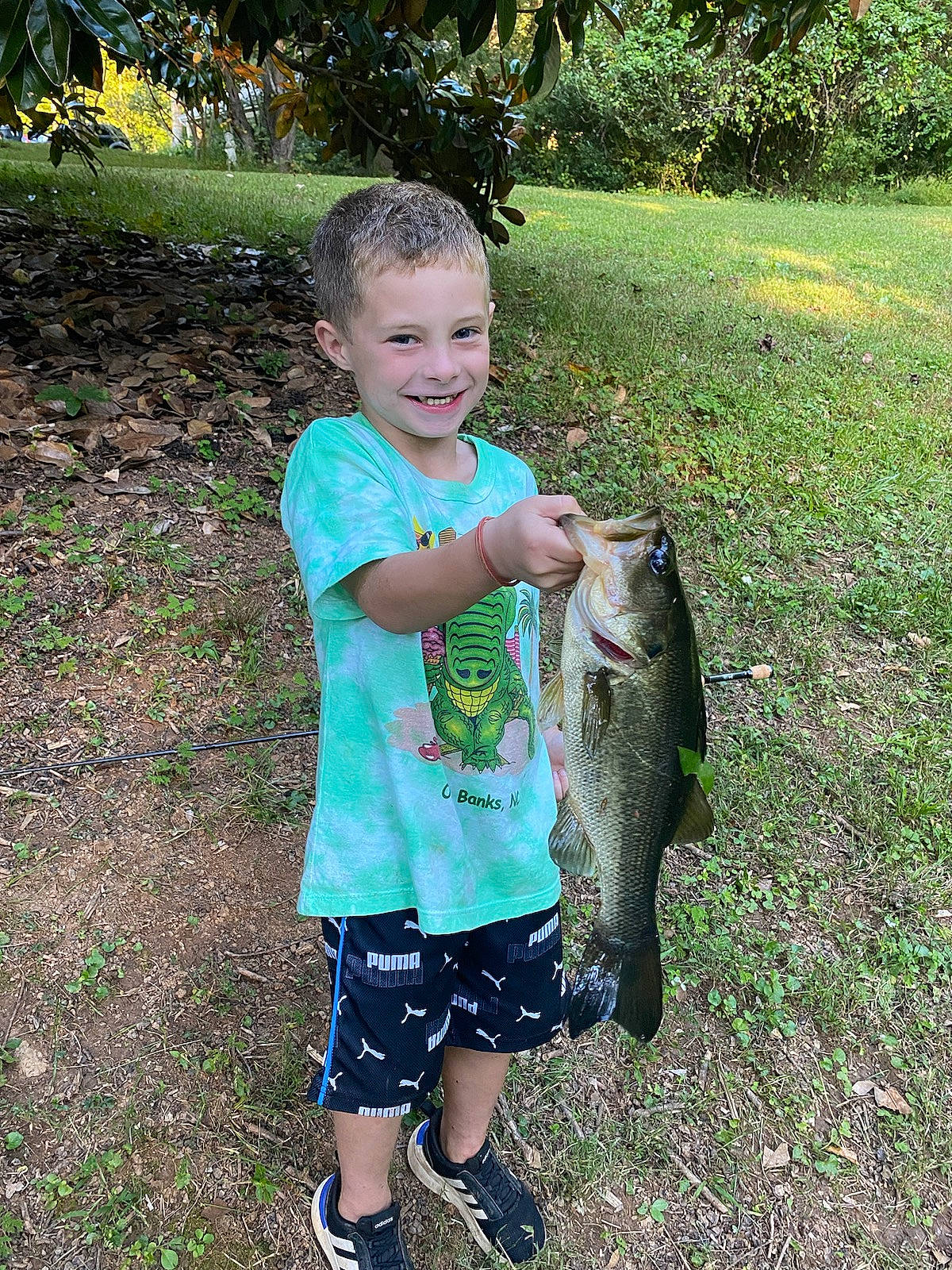 Wyatt is registered to the contest to win money with this photo: bermuda_shorts, bony_fish, fin, fish, fisherman, fishing, garden, grass, happy, joy, people_in_nature, person, plant, ray_finned_fish, recreation, recreational_fishing, shorts, smile, t_shirt, tail