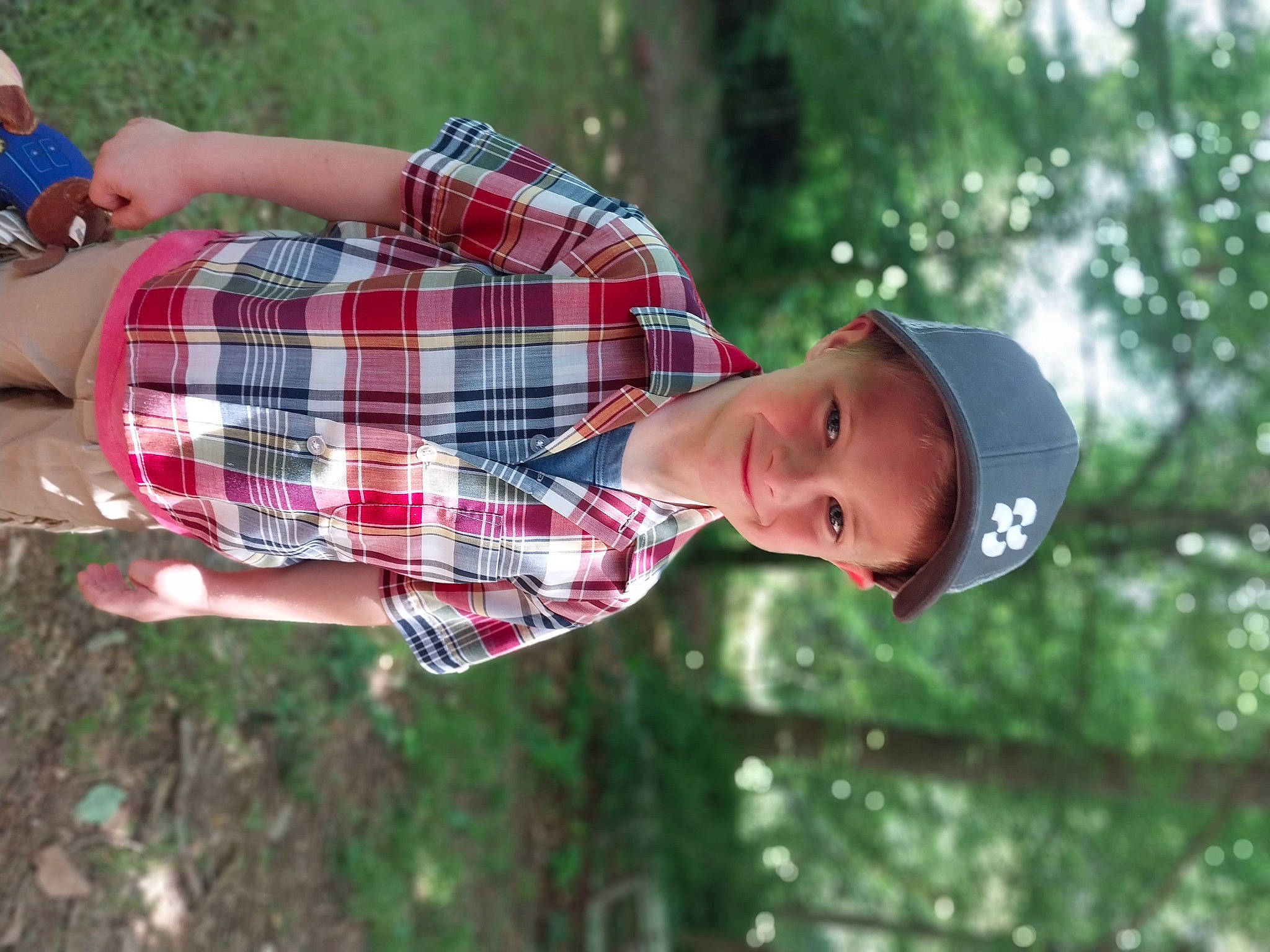 Wyatt joined the competition — help win amazing prizes! cap, child, clothing, fun, grass, happy, hat, headwear, joy, leisure, pattern, people_in_nature, person, plaid, plant, recreation, smile, tartan, toddler, tree