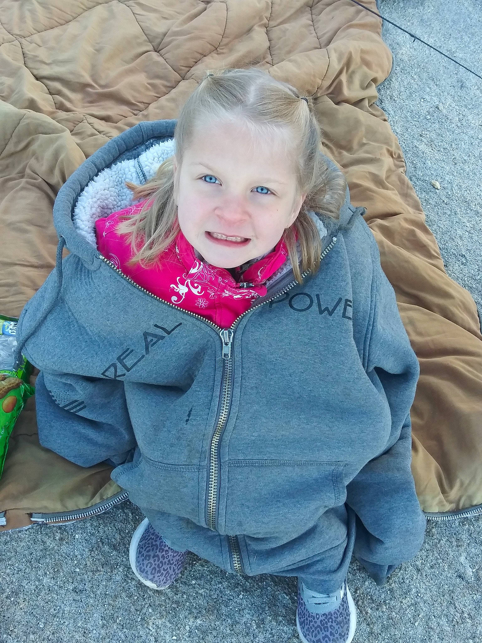 Teigan is registered to the contest to win money with this photo: baby, blond, cheek, child, eye, face, grass, head, hoodie, jacket, joy, nose, outerwear, people, person, plant, play, sitting, skin, smile