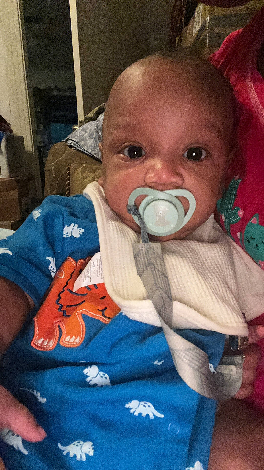 Darius is registered to the contest to win money with this photo: baby, baby_products, baby_toddler_clothing, blue, cheek, child, chin, comfort, drinkware, eyebrow, eyelash, fun, iris, lip, mouth, nose, person, sitting, skin, sleeve