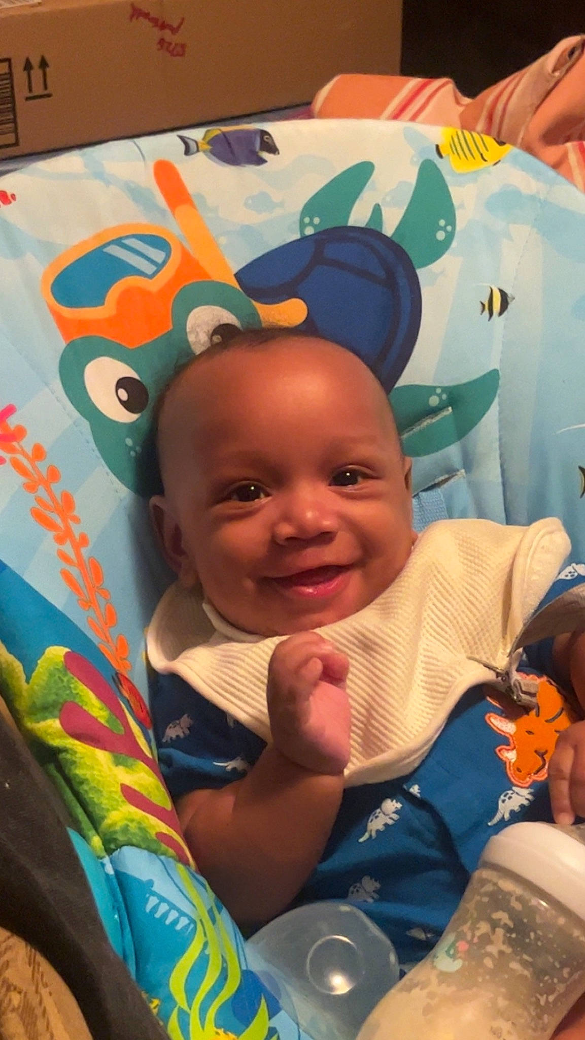 Darius joined the competition — help win amazing prizes! art, baby, baby_products, baby_toddler_clothing, cheek, child, event, fun, happy, joy, leisure, mouth, orange, person, room, sitting, smile, t_shirt, textile, toddler