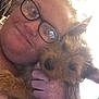 accessories, animal, baby, bodypart, canine, couch, dog, face, finger, glasses, hand, head, person, pet, photography, portrait, puppy, skin, tattoo, terrier
