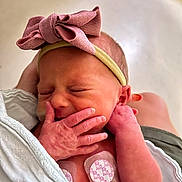 Madison joined the competition — help win amazing prizes! newborn, baby, infant, headband, pink_bow, blanket, sleeping, hand, skin, person, closeup, cute, peaceful, resting, hospital, medical_patch, tender, soft_light, indoors, portrait