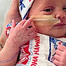 baby, infant, headband, hand, nasal_tube, hospital, person, clothing, pattern, aloha_hawaii, cute, newborn, portrait, skin, fingers, holding, expression, care, medical, treatment
