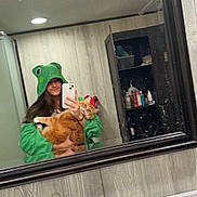 Phoenix joined the competition — help win amazing prizes! bathroom, cabinet, casual, cat, faucet, green_clothing, hoodie, indoor, long_hair, mirror, orange_cat, person, phone, reflection, selfie, sink, smudged_mirror, soap_dispenser, toiletries, wooden_wall