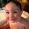 toddler, smiling, bath, wet_hair, indoors, kitchen, microwave, face, child, necklace, skin, happy, closeup, portrait, water, sitting, cute, expression, background, tile_floor