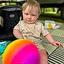 Onyx joined the competition — help win amazing prizes! baby, ball, blue_eyes, child, clothing, colorful, cute, daylight, grass, light_hair, mat, outdoor, patterned, person, play, short_sleeve, sitting, stroller, toddler, toy