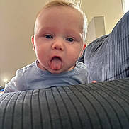 Onyx joined the competition — help win amazing prizes! baby, blue_shirt, child, couch, cute, expression, face, furniture, head, home, indoor, infant, person, playful, portrait, skin, striped, tongue, tongue_out, young