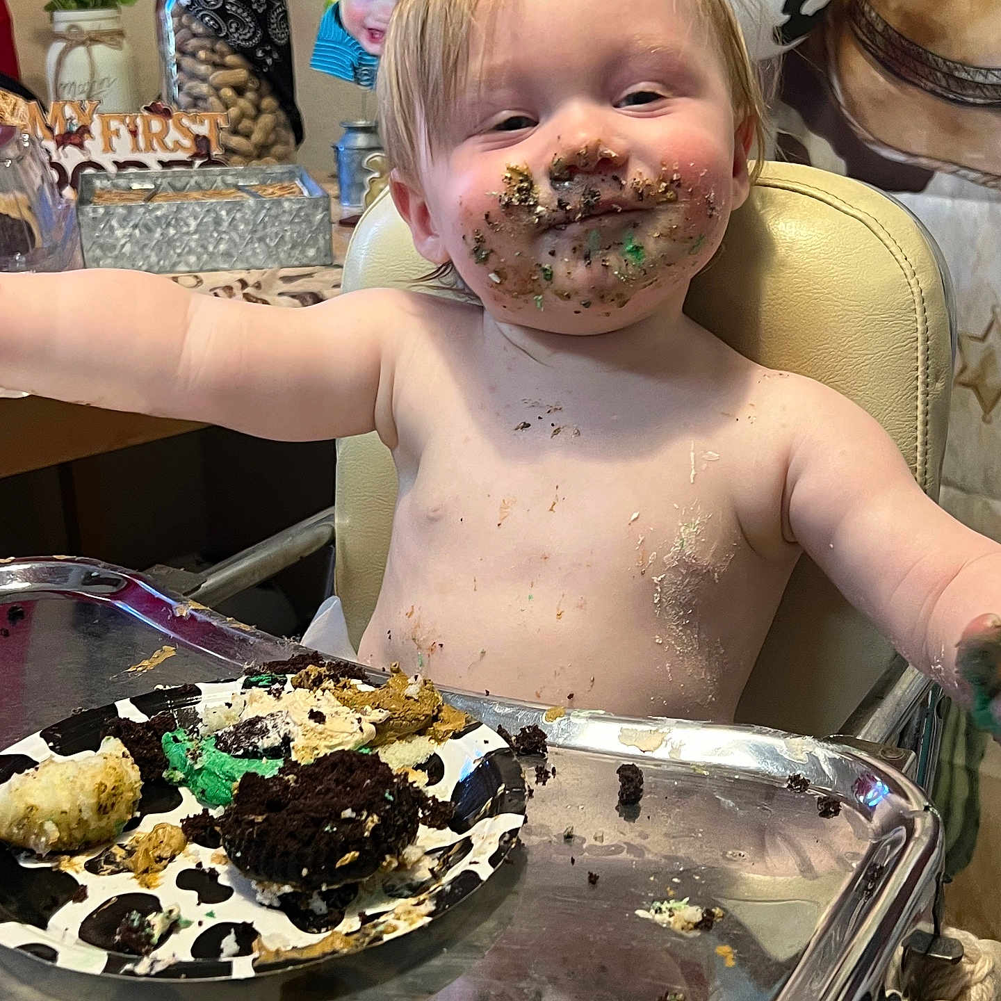 Onyx is registered to the contest to win money with this photo: arms_outstretched, birthday, cake, celebration, cheeks, child, crumbs, dirtied, food, frosting, fun, happy, high_chair, indoor, messy_face, person, plate, smile, toddler, young_child