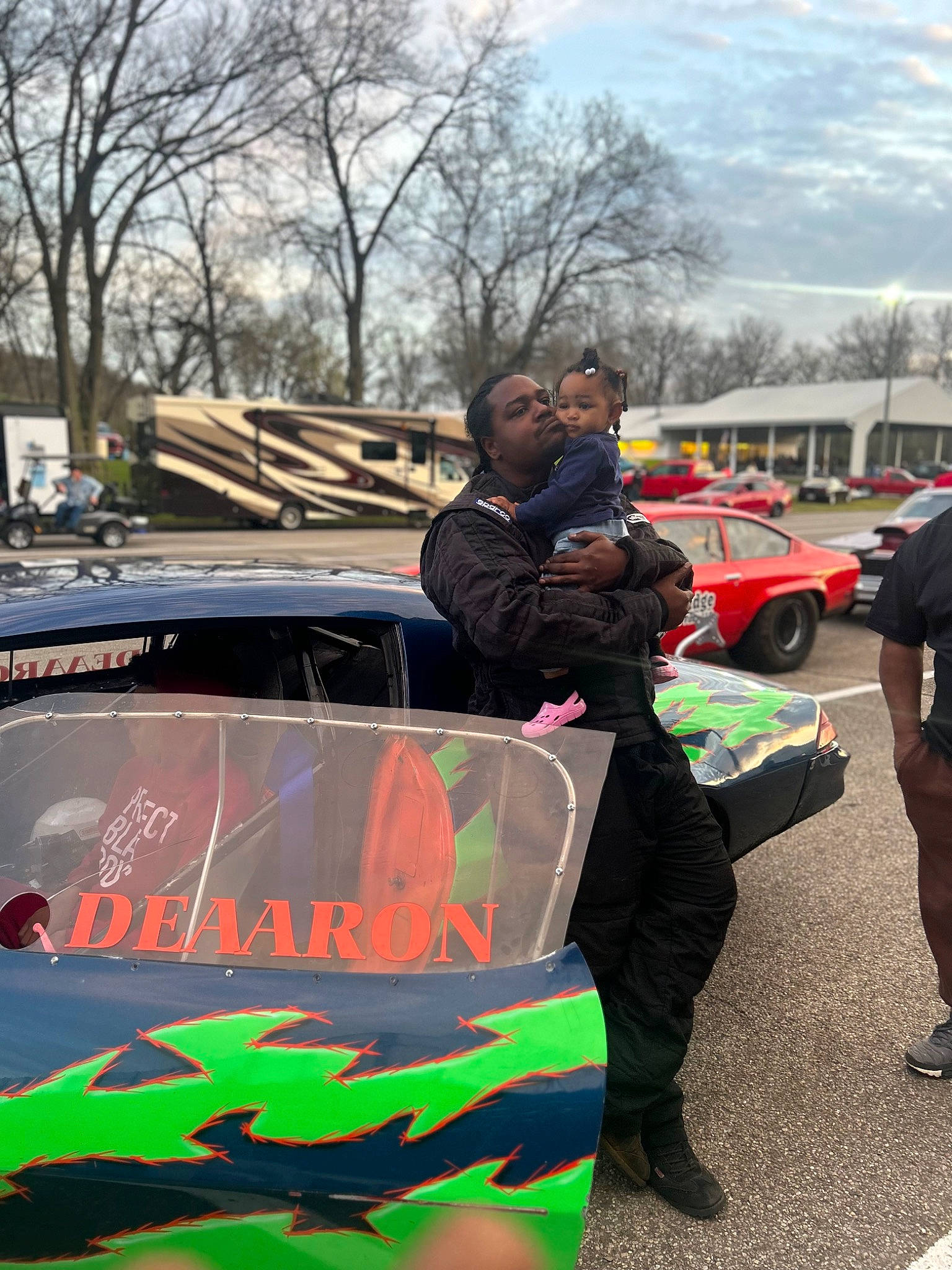 Ablessing Simpson joined the competition — help win amazing prizes! asphalt, auto_part, automotive_design, automotive_exterior, automotive_tire, automotive_wheel_system, car, crowd, event, hood, luxury_vehicle, motor_vehicle, pedestrian, person, personal_protective_equipment, public_event, sky, tree, vehicle, vehicle_door