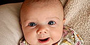 Violet Mae joined the competition — help win amazing prizes! baby, blanket, blue_eyes, child, close_up, cute, expression, face, floral_clothing, happy, head, indoor, infant, newborn, person, portrait, skin, smile, soft_texture, young