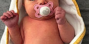 Violet is registered to the contest to win money with this photo: baby, background, closeup, cozy, cute, eyes, face, gray, hand, infant, newborn, pacifier, pink, portrait, skin, soft, towel, white, wrapped, yellow
