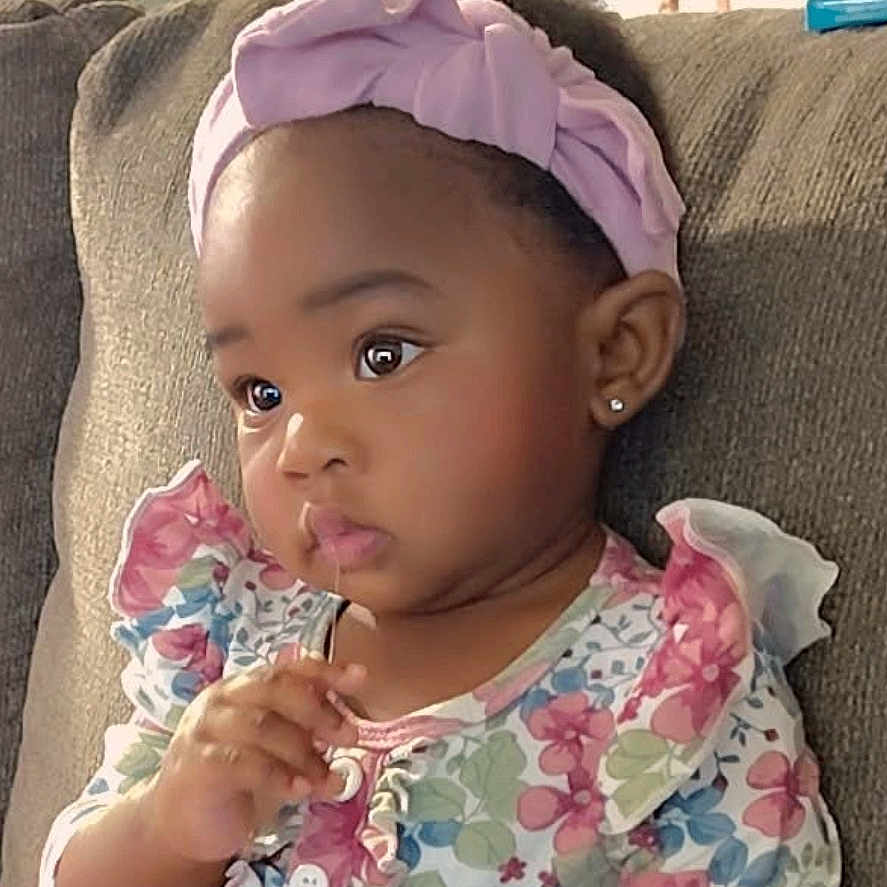 Blessing joined the competition — help win amazing prizes! blue_pants, casual, child, couch, curious, cute, earrings, expression, floral_clothing, girl, headband, home, indoor, long_sleeves, pink, portrait, seated, small_hands, toddler, young_child