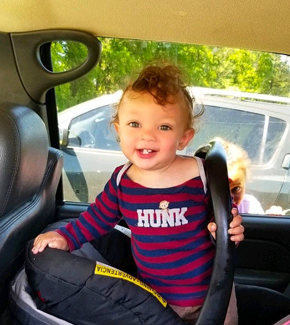 Preston is registered to the contest to win money with this photo: auto_part, automotive_exterior, baby_in_car_seat, car, car_seat, car_seat_cover, child, city_car, driving, family_car, joy, person, seat_belt, smile, steering_part, steering_wheel, toddler, vehicle, vehicle_door