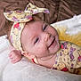 Elaina is registered to the contest to win money with this photo: baby, infant, smile, headband, yellow_clothing, winnie_the_pooh, blanket, tulle_skirt, soft_texture, cute, child, portrait, happy, indoors, laying_down, head, face, hand, clothing_pattern, bedroom