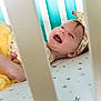 Elaina joined the competition — help win amazing prizes! baby, crib, yellow_skirt, headband, smiling, happy, infant, bed, sleepwear, toddler, child, furniture, indoor, portrait, face, person, cute, colorful, pattern, nursery