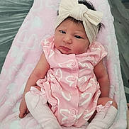 Esme is registered to the contest to win money with this photo: baby, infant, child, pink_outfit, headband, bow, socks, blanket, heart_pattern, soft_texture, cute, portrait, indoors, newborn, lying_down, person, small_child, clothing, expression, baby_girl