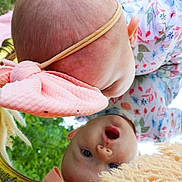 Haven joined the competition — help win amazing prizes! baby, headband, mirror, reflection, grass, outdoor, curious, closeup, infant, face, expression, pink, blue, floral, clothing, soft, texture, golden, child, nature