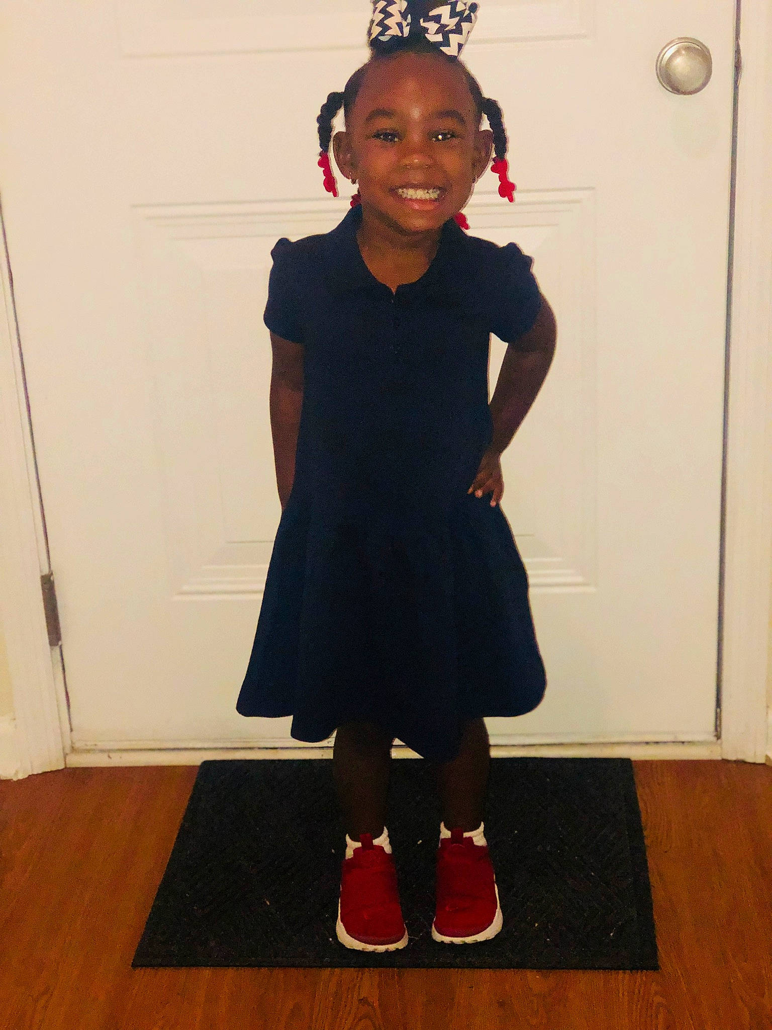 Keira is registered to the contest to win money with this photo: black, child, clothing, costume, dress, flooring, footwear, joint, joy, knee, little_black_dress, person, shoe, shoulder, standing, style, toddler, uniform