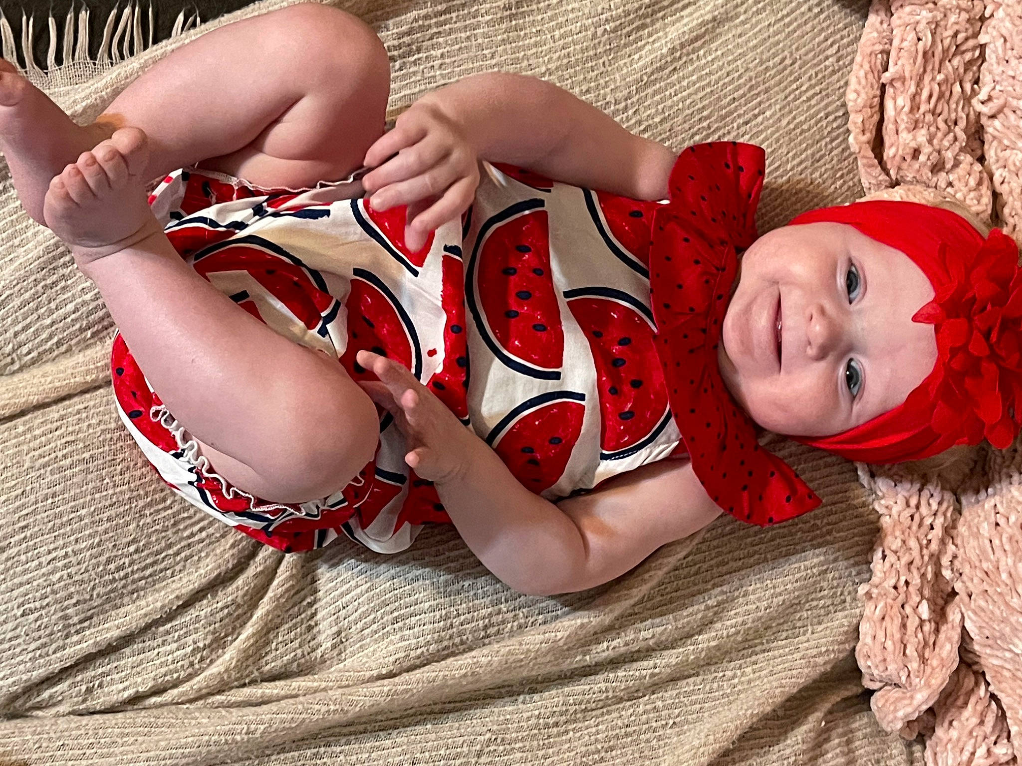 Maeve is registered to the contest to win money with this photo: abdomen, arm, chest, comfort, elbow, flash_photography, hand, happy, headwear, human_body, human_leg, knee, leg, mouth, pattern, person, skin, smile, thigh, toddler