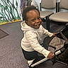 Tymir is registered to the contest to win money with this photo: art, baby, black_pants, carpet, chairs, child, childrens_room, curious, floor, footwear, happy, hoodie, indoor, mural, person, playful, smiling, stroller, toddler, young_child