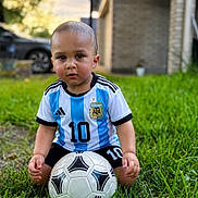 Dawson joined the competition — help win amazing prizes! toddler, child, soccer_ball, grass, outdoor, sportswear, jersey, argentina, number_10, shorts, greenery, portrait, young_child, playing, ball, summer, daylight, focused, cute, sport