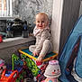 Aurora is registered to the contest to win money with this photo: baby, child, toy_box, superhero, hulk, indoor, pajamas, smile, toy_car, toy_lamp, plush_toy, tent, window, carpet, floor, person, face, colorful, happy, room