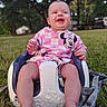 baby, child, infant, sitting, outdoor, grass, baby_seat, pink_clothing, minnie_mouse, smiling, happy, cute, nature, trees, daylight, playtime, seat, feet, portrait, person