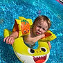 toddler, child, pool, water, floatie, swimming, yellow, inflatable, summer, outdoor, sunlight, splash, cute, fun, expression, puddle, play, arm_floaties, face, blue