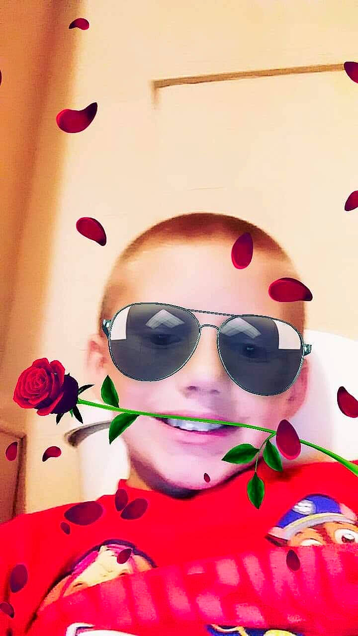 Gerald Simpson is registered to the contest to win money with this photo: child, cool, eyewear, flower, glasses, head, illustration, joy, lip, nose, person, petal, photography, pink, plant, red, selfie, skin, smile, sunglasses