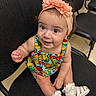 Abigail is registered to the contest to win money with this photo: baby, child, infant, headband, flower, colorful_clothing, fruit_pattern, sitting, chair, indoor, smiling, happy, white_sandals, cute, person, portrait, closeup, skin, eyes, hand