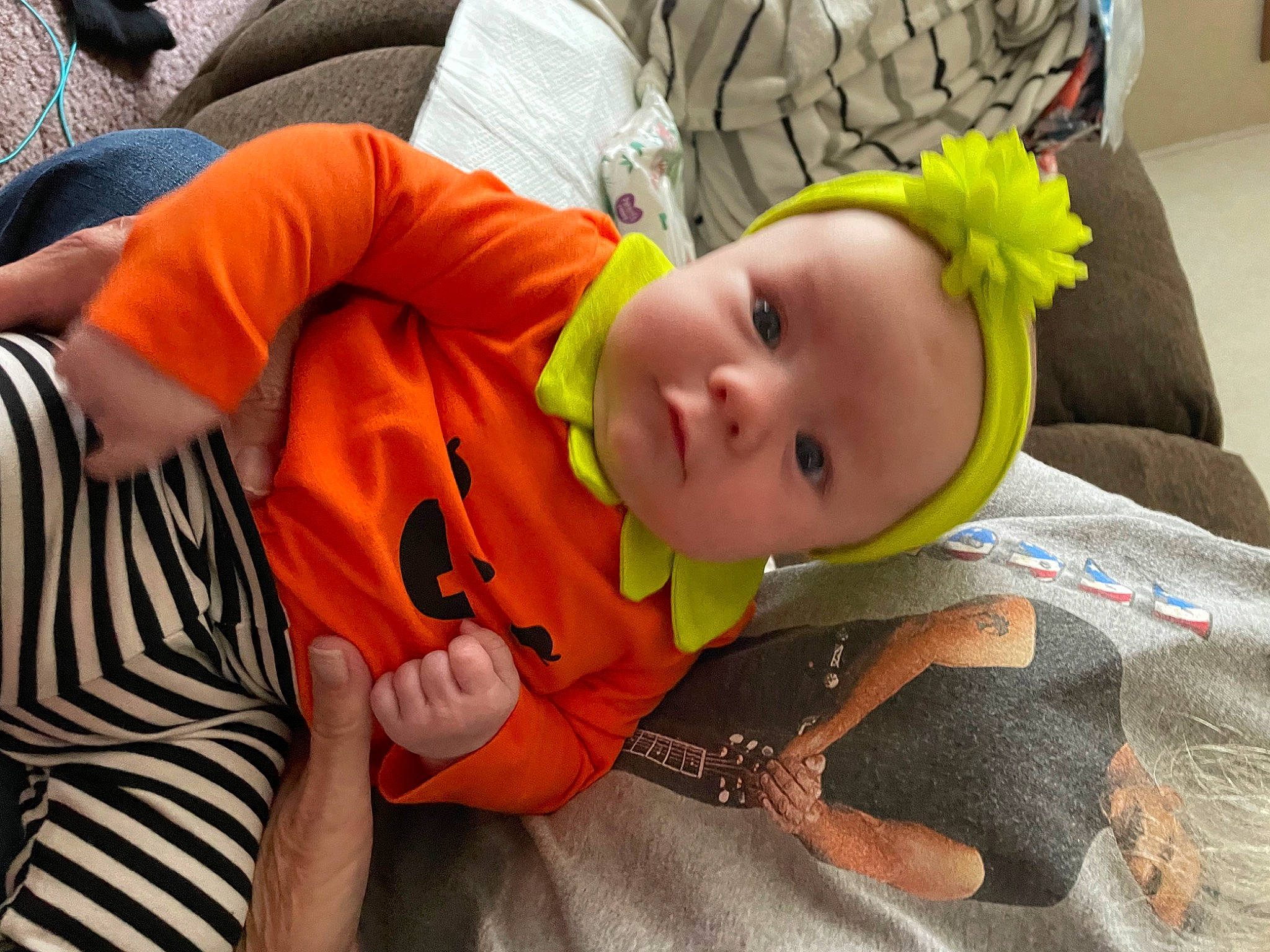 Lillie is registered to the contest to win money with this photo: baby, baby_products, baby_toddler_clothing, cheek, child, comfort, finger, fun, grass, happy, orange, person, sitting, toddler
