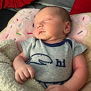 Atlas is registered to the contest to win money with this photo: baby, sleeping, blanket, pillow, clothing, onesie, infant, hand, face, bed, red, gray, pink, soft, cute, peaceful, resting, child, indoors, newborn
