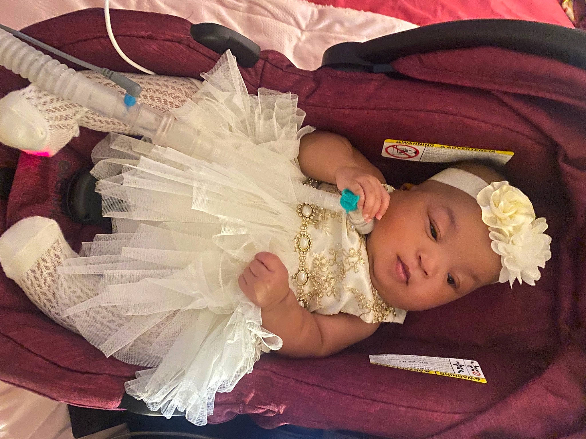 Khalani joined the competition — help win amazing prizes! baby, baby_products, baby_toddler_clothing, bridal_accessory, child, costume_hat, dress, embellishment, event, fashion_accessory, hand, happy, hat, headgear, headpiece, headwear, jewellery, person, pink, sitting