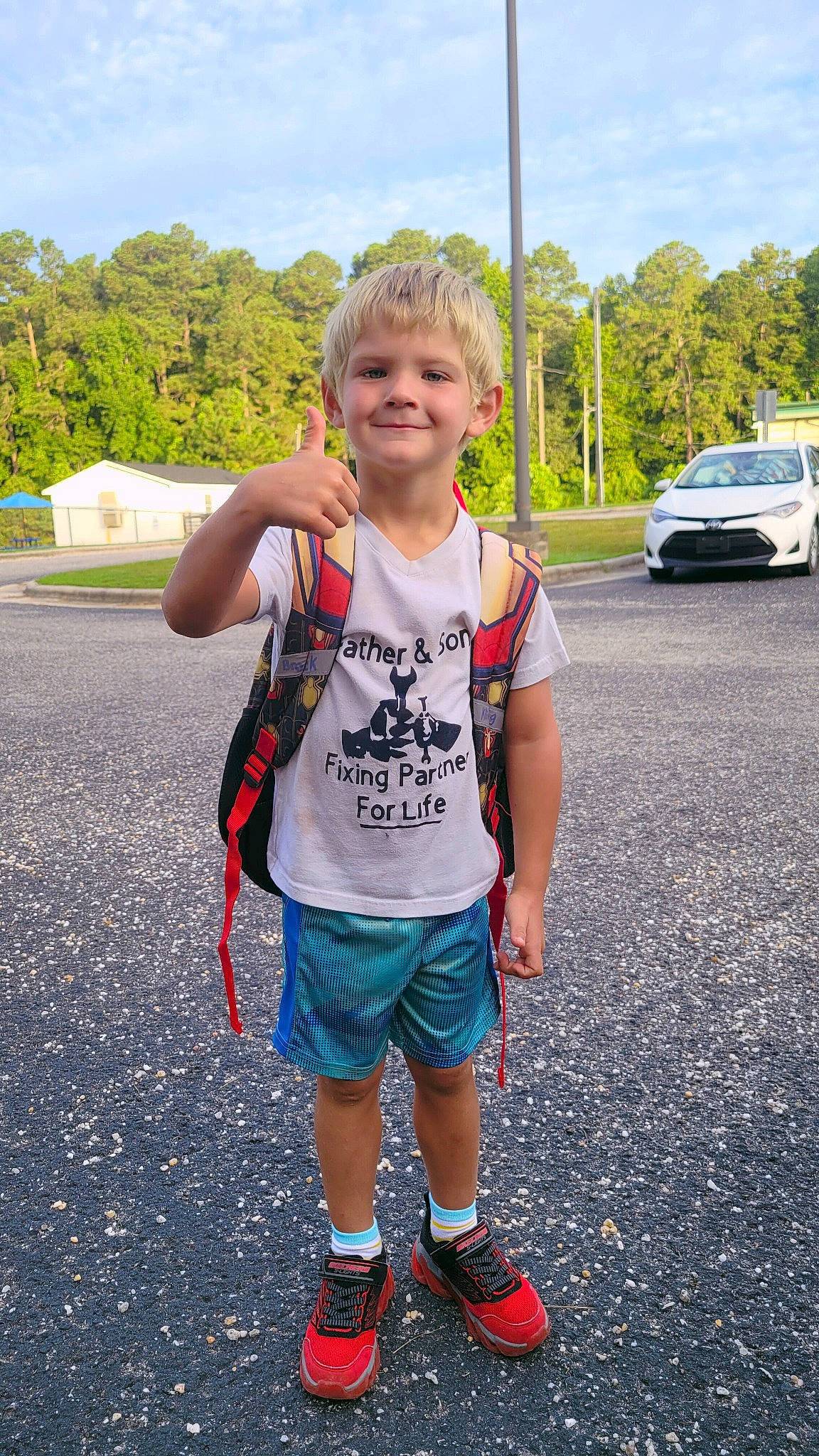 Brock is registered to the contest to win money with this photo: asphalt, bumper, car, electric_blue, fun, grass, joy, leisure, pattern, person, recreation, road, shorts, sky, sleeve, smile, sportswear, summer, t_shirt, toddler