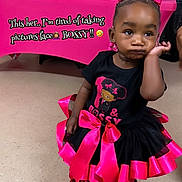 Jazzlyn joined the competition — help win amazing prizes! toddler, child, girl, black_hair, pink_bow, black_dress, pink_ribbons, floor, indoor, portrait, expression, attitude, cartoon, table, letters, celebration, party, colorful, cute, fashion