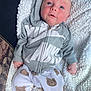 baby, infant, hoodie, nike, blanket, bear_pattern, clothing, cute, face, expression, eyes, hand, soft_texture, white, gray, pants, lying_down, cozy, young_child, portrait