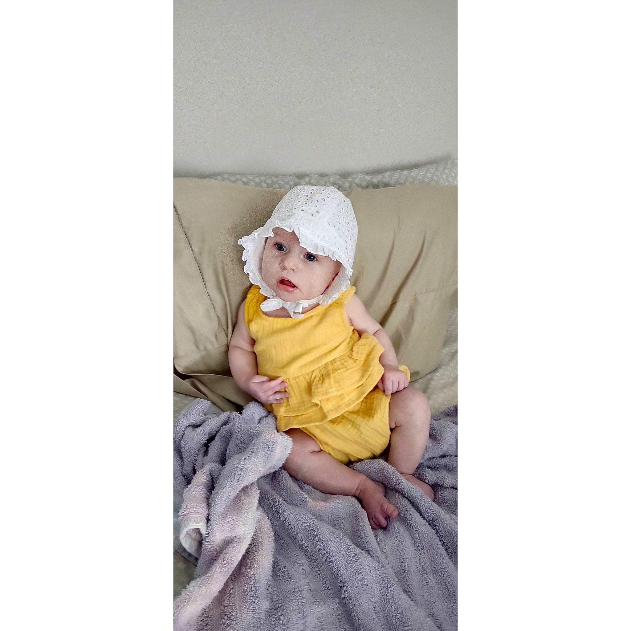 Lucy joined the competition — help win amazing prizes! baby, baby_products, baby_toddler_clothing, beanie, cap, child, comfort, fashion_accessory, fictional_character, fur, headgear, headwear, hood, linens, magenta, outerwear, pattern, person, picture_frame, sitting