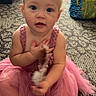baby, child, tutu, pink_dress, headband, feather_toy, carpet, indoor, blue_eyes, sitting, person, cute, infant, floor, backpack, chair, blond_hair, curious, portrait, toddler