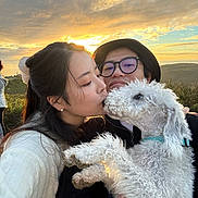 Chancey joined the competition — help win amazing prizes! affection, casual_clothing, clouds, couple, dog, fur, glasses, grass, happy, hat, holding, kiss, love, man, nature, outdoor, portrait, sky, sunset, woman
