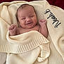 baby, blanket, smiling, knitted, infant, cute, happy, wrapped, fist, cozy, portrait, newborn, child, soft, texture, warm, expression, closeup, face, indoors