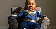 Zymir joined the competition — help win amazing prizes! armchair, baby, baby_boy, cape, carpet, child, costume, couch, cute, funny, furniture, happy, indoor, person, portrait, sitting, smile, superhero, superman_costume, young_child