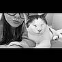 animal, black_and_white, cat, close_up, companion, cozy, cute, face, friendship, fur, glasses, home, indoor, person, pet, portrait, relaxed, resting, sleepy, whiskers