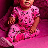 Natalie joined the competition — help win amazing prizes! toddler, child, pink, pajamas, minnie_mouse, bed, pillow, clothing, footwear, sitting, indoors, person, cute, smiling, face, hair, home, cozy, soft, blanket